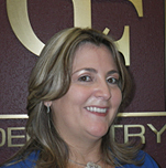 The image features two individuals posing for a photograph with a sign displaying CEO in the background, suggesting they are at a professional event or office setting.